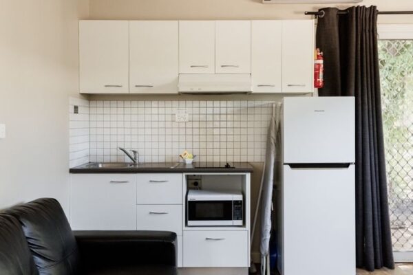 Breeze Holiday Parks - Katherine, One-Bedroom Cabin, living space, kitchen, fridge and microwave