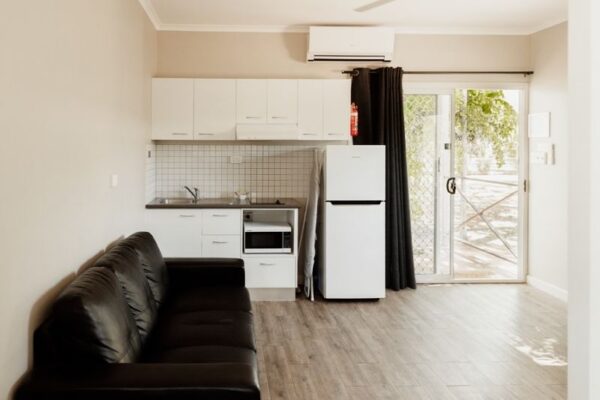Breeze Holiday Parks - Katherine, One-Bedroom Cabin, living space, kitchen, fridge and microwave