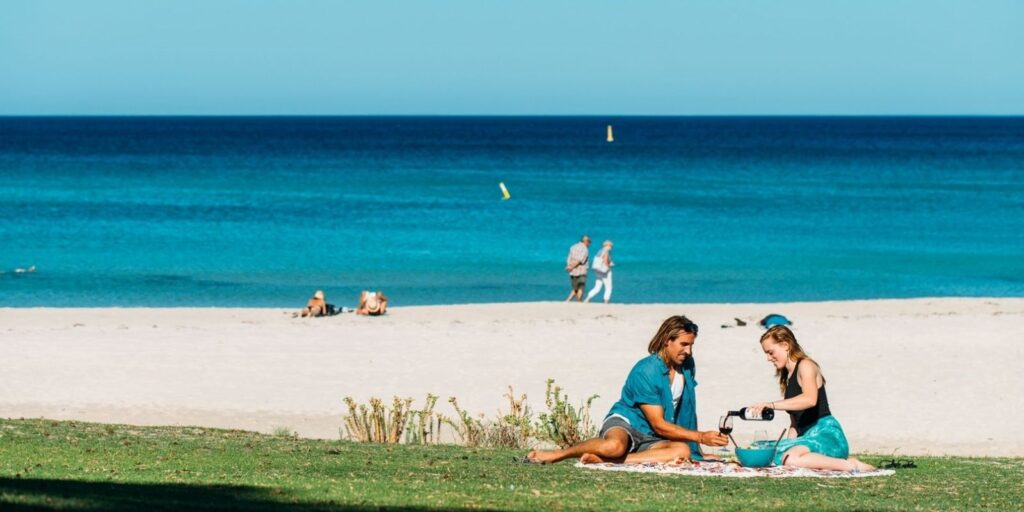 The Best Picnic Spots Near Breeze Holiday Parks, couple enjoying a picnic at Meelup Beach