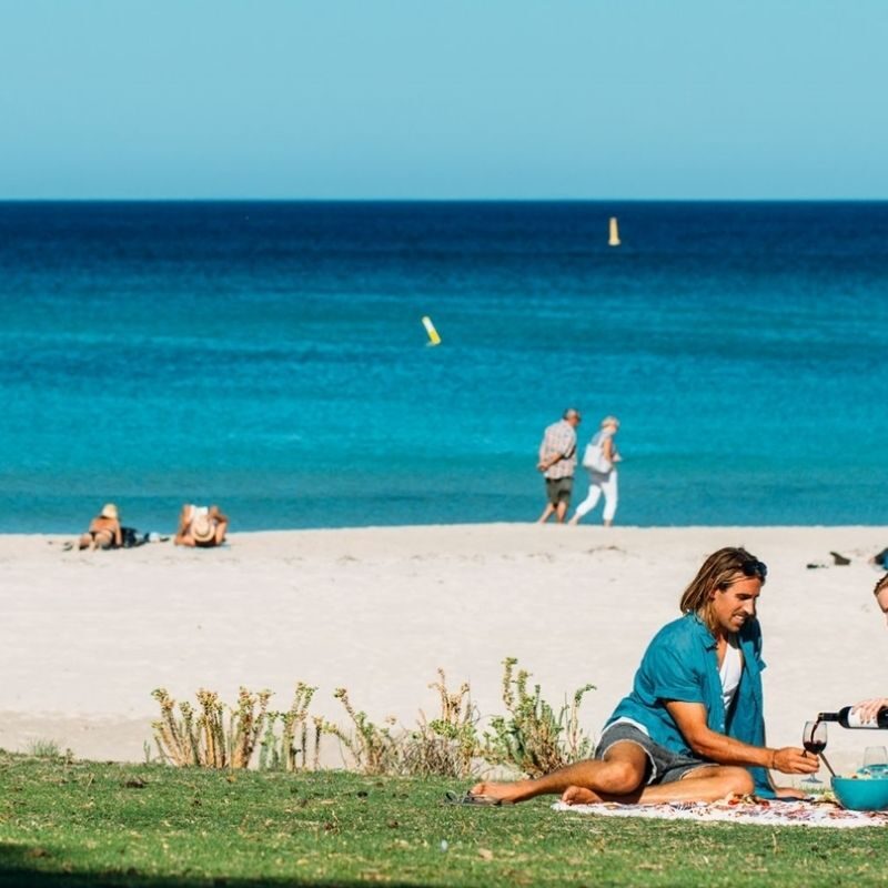 The Best Picnic Spots Near Breeze Holiday Parks, couple enjoying a picnic at Meelup Beach