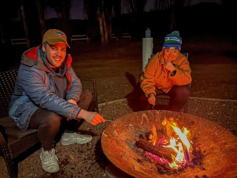 Couple enjoying toasting marshmallows on a fire pit at BIG4 Breeze Holiday Parks - Eildon
