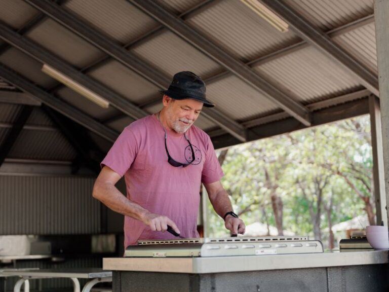 Man cooking food on a BBQ at BIG4 Breeze Holiday Parks - Katherine